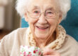 Happy senior woman sipping a warm cup of tea